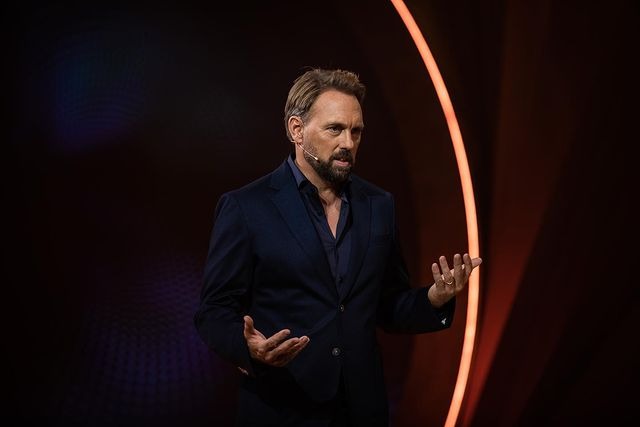 Steven Gatjen wearing black suit during his performance.